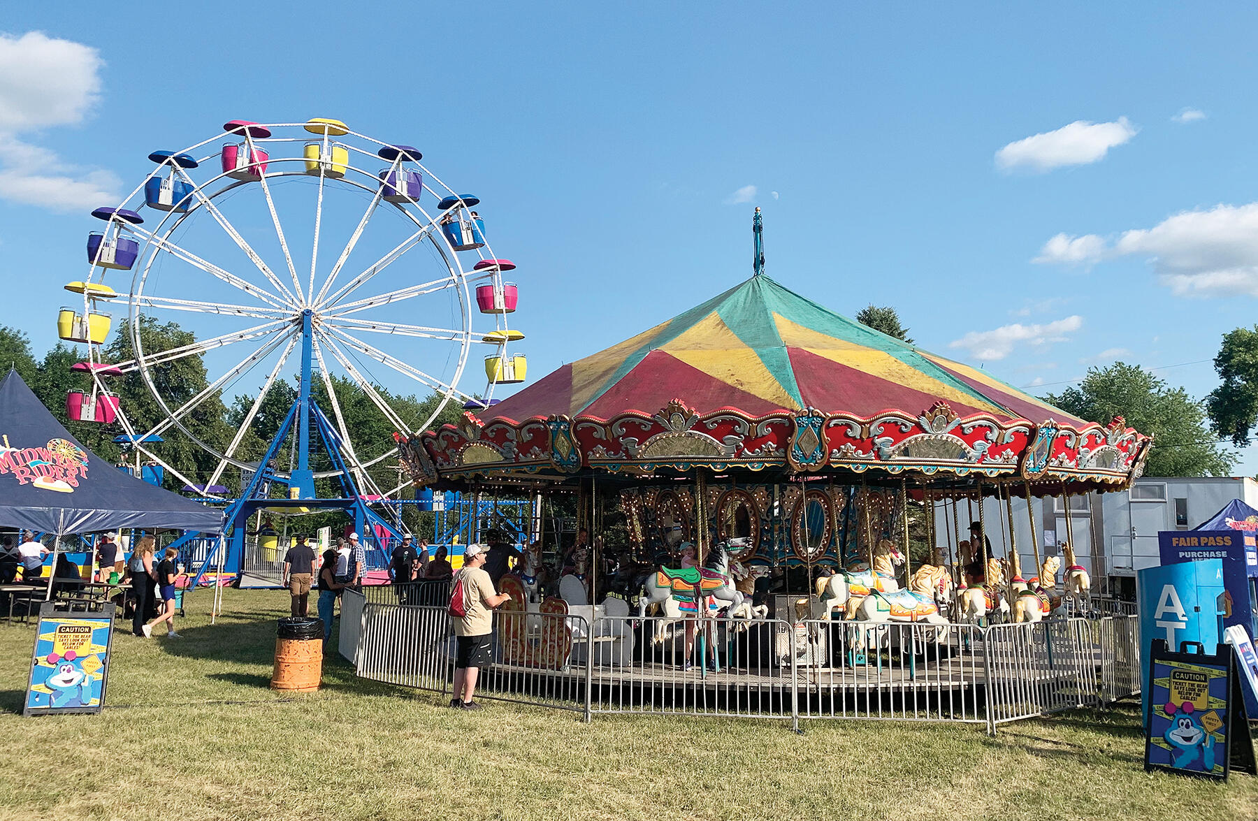 Two fair classics, the Ferris wheel and carousel, provided many thrills and memories for riders at the Wright County Fair, which ran July 22-26 in Howard Lake. (Photos by Mike Gesellchen)