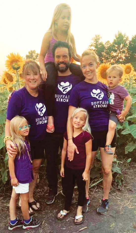 Dani with her family and Mayor Teri Lachermeier (left) at the sunflower field wearing Buffalo Strong gear. Dani is surrounded by her children Eden, Shiloh, Olive, Abel, next to her husband, Cameron. (Photo submitted by Dani Palmer)