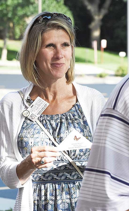 Andrea Jung, President and CEO of Guardian Angels Elim Home Care and Hospice, hands out butterflies to attendees