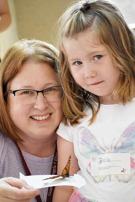 Hospice Clinical Manager Beth Ellingson and her granddaughter with a butterfly to release.