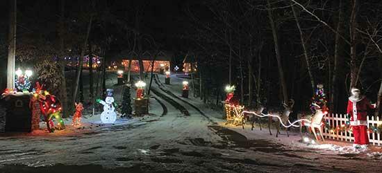 Santa Claus, his reindeer, and a snowman are just a few of the Christmas personalities greeting visitors at this rural Buffalo home. (Photo by Tom McDonnell)