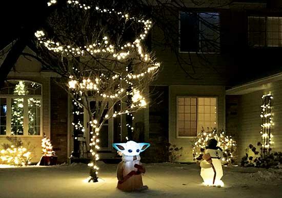 Bushes and trees light up this front yard featuring Grogu, also known as Baby Yoda, from the Disney+ series ‘The Mandalorian’ and Frosty the Snowman in Monticello. (Photo by Emily Vojtech)