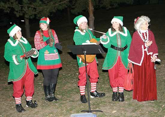 Mrs. Claus (right) and Santa’s helpers sang Christmas carols following the tree-lighting ceremony that took place at 5 p.m. at Sturges Park.
