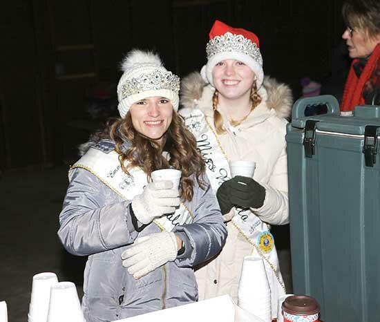 Buffalo Royalty members, Princess Emma Hill (left) and Queen Mackenzie Fladung (right) served free hot chocolate and cookies for the hundreds of people that showed up to Sturges Park for Deck the Halls.