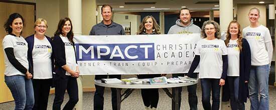 Impact Christian Academy Launch Committee members gather with smiles in front of the ICA banner before their Nov. 15 meeting. The committee is responsible for the planning and preparation for the school opening in Sept. 2022. Members left to right: Abigail Helmbrect, Kristi Anderson, Jen Mutterer, Bryan Vantehof, Rissa Schrick, Marcus Hammerseng, Lisa Downer, Kendra Durst, and Kelli Hammerseng. (Photos by Emily Vojtech)