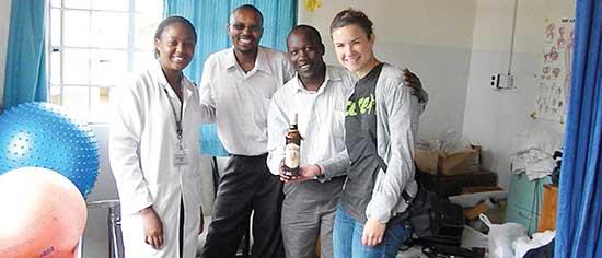 Cassie, far right, with the CURE physical therapists (left to right): Miriam, David, and Elvis.