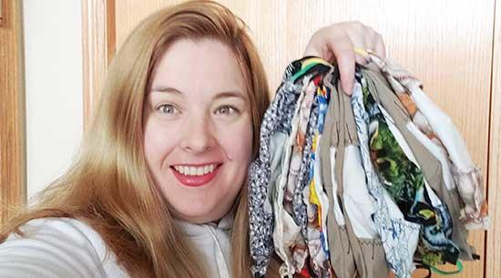 Alison Sturm with a handful of completed masks, ready to be washed and packaged.